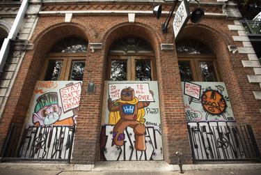 A positive message is spray painted on a business on Sixth Street in Austin. Many businesses have closed their doors on the strip as a result of the recent coronavirus outbreak. March 25, 2020.
