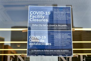 A sign at Dallas City Hall announces closures related to COVID-19.
