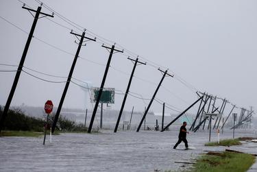 A man walked through floodwater after surveying his property in Rockport, which was hit by Hurricane Harvey in 2017.