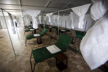 Cots are spread out along a tiled floor in one of the medical tents at NRG Park in Houston on April 11, 2020.