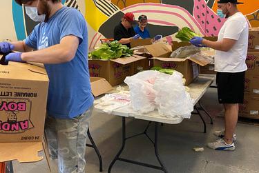 Volunteers at the CitySquare Food Bank in Dallas help unpack a shipment of produce.